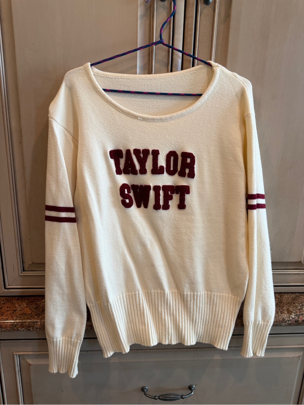 Cream Crewneck Sweater with Burgundy Lettering and Sleeve Stripes - Taylor Swift